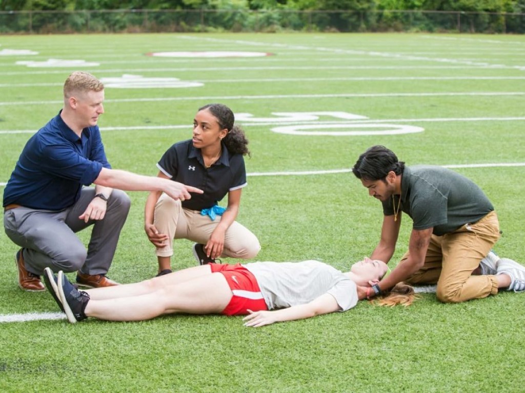 Athletic Trainers On Field Practicing