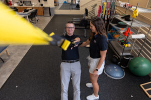 Athletic training students participating in hands-on clinical education