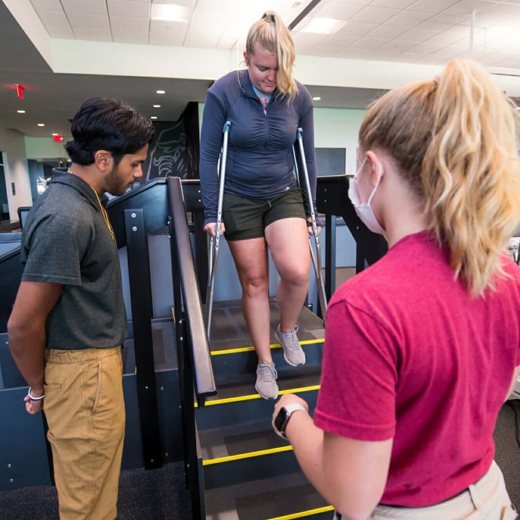 Athletic Trainers Monitor Student on Crutches