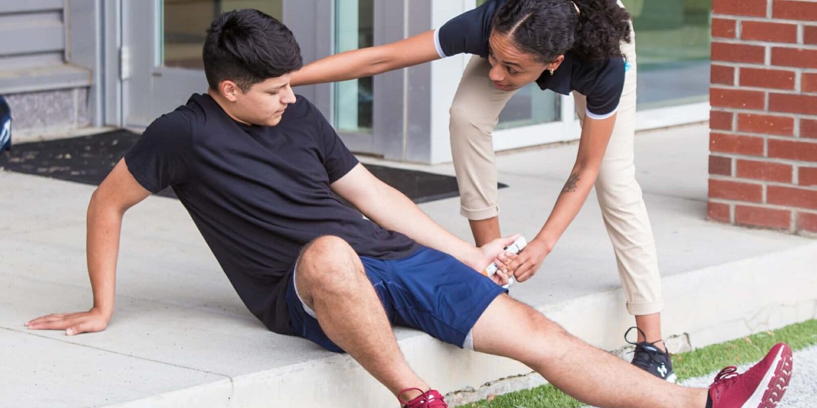 Athletic Trainer Helping Injured Patient