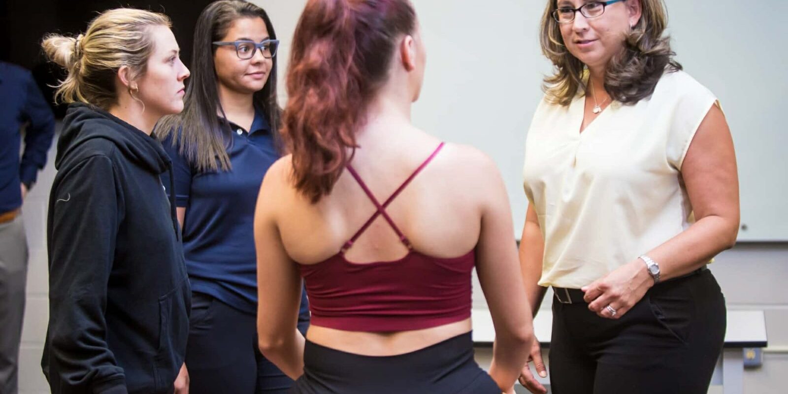 Group of Trainers Meeting With Athlete