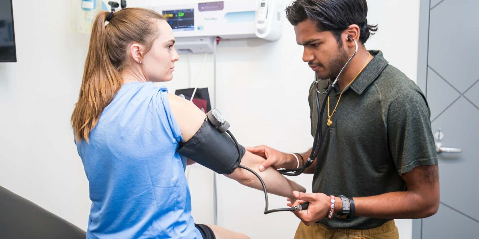 Athletic Trainer Takes Patient Blood Pressure