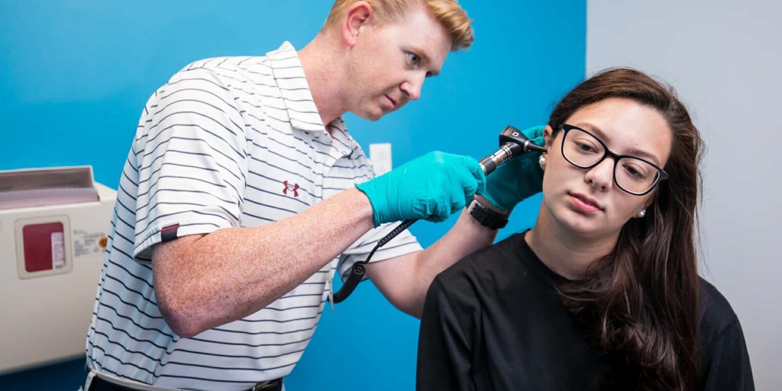 Athletic Trainer Inspecting Patient's Ear